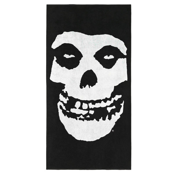 Stylized white skull face design on black background for Fiend Skull Beach Towel