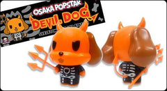 Orange cartoon dog figurine with devil horns in a skeleton suit design