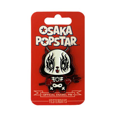 Kawaii black metal enamel pin of a cartoon cat with large eyes and skeleton body design