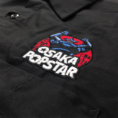Embroidered Osaka Popstar logo with motorcycle on black fabric work shirt design